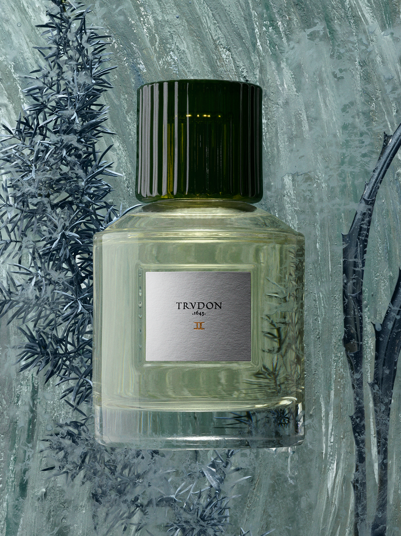 Cire Trudon | II Deux Perfume | Scent Lounge | Lifestyle Image of Perfume Bottle, Blue Background
